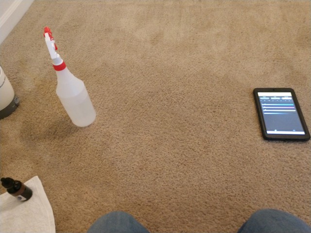 A bottle and tablet on the floor